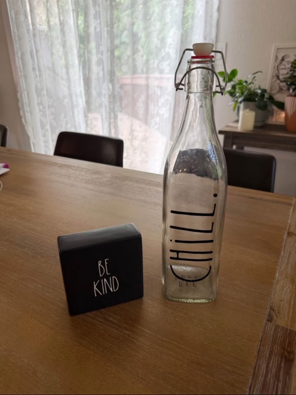 Rae Dunn clear glass bottle desk/shelf accessory.